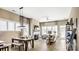 Open-concept living room with fireplace, dining area, and large windows for natural light at 7324 Jolly Brook Dr, Charlotte, NC 28215
