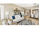 Inviting living room with neutral tones, comfortable seating, and a view into the dining area at 7324 Jolly Brook Dr, Charlotte, NC 28215