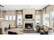 Spacious living room with fireplace, comfortable seating, and views of the outdoors at 7324 Jolly Brook Dr, Charlotte, NC 28215