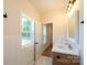 Bathroom features a modern vanity with marble countertop, fixtures, and wood cabinetry at 7426 Hambright Rd, Huntersville, NC 28078