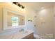 Modern bathroom featuring a vanity with marble countertop and a tiled walk-in shower at 7426 Hambright Rd, Huntersville, NC 28078