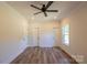 Spacious bedroom with hardwood floors, a modern ceiling fan, and trim work at 7426 Hambright Rd, Huntersville, NC 28078