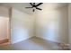 Bedroom features neutral carpeting, a ceiling fan, and a neutral walls at 7426 Hambright Rd, Huntersville, NC 28078