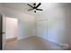 Bedroom features neutral carpeting, a ceiling fan, and a closet for storage at 7426 Hambright Rd, Huntersville, NC 28078
