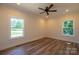 Spacious bedroom featuring wood floors, natural light, and a ceiling fan at 7426 Hambright Rd, Huntersville, NC 28078