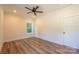 Bright bedroom features hardwood floors, a ceiling fan, and natural light from the window at 7426 Hambright Rd, Huntersville, NC 28078