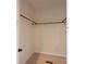Walk-in closet boasts ample storage space with wood rods and shelving at 7426 Hambright Rd, Huntersville, NC 28078