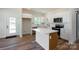 Bright, stylish kitchen with white cabinets, a large island, and stainless steel appliances at 7426 Hambright Rd, Huntersville, NC 28078