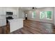 A sleek island with quartz countertop highlights a bright kitchen with stainless steel appliances at 7426 Hambright Rd, Huntersville, NC 28078