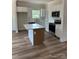 Bright kitchen with white cabinets, stainless steel appliances, and a center island with marble top at 7426 Hambright Rd, Huntersville, NC 28078