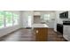 Bright open kitchen featuring an island with quartz countertop and white cabinetry at 7426 Hambright Rd, Huntersville, NC 28078
