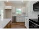 Well-lit kitchen features white cabinetry, stainless steel appliances, and granite countertops at 7426 Hambright Rd, Huntersville, NC 28078