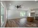 Open-concept living area featuring wood floors, modern lighting, and a stylish kitchen island at 7426 Hambright Rd, Huntersville, NC 28078