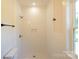 New shower is tiled and features bronze fixtures, a built-in niche, and a hand towel rack at 7426 Hambright Rd, Huntersville, NC 28078