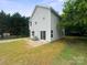 View of the rear exterior of home and yard showing concrete patio and AC unit at 746 Shasta Nw St, Concord, NC 28027