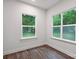 A bright bedroom is showcased with wood-look flooring, light walls, and ample natural light at 746 Shasta Nw St, Concord, NC 28027