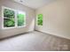 Bright bedroom showcasing natural light, neutral paint, and a plush carpet at 746 Shasta Nw St, Concord, NC 28027