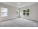 Sunlit bedroom with plush carpeting, neutral walls, and large windows that let in natural light at 746 Shasta Nw St, Concord, NC 28027