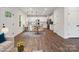Open dining area with modern chandelier, connecting to the kitchen with stainless steel appliances at 746 Shasta Nw St, Concord, NC 28027