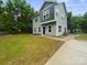 View of this lovely home featuring gray siding, newly installed grass, and a paved driveway at 746 Shasta Nw St, Concord, NC 28027