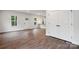 Open-concept living area showing wood-look flooring, an island, and plenty of bright, natural light at 746 Shasta Nw St, Concord, NC 28027