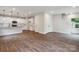 Open-concept living area with hardwood floors, white walls and kitchen with modern appliances at 746 Shasta Nw St, Concord, NC 28027