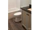 The bathroom has a toilet next to a modern vanity with black granite counters at 8222 Madison Ln, Hickory, NC 28602