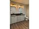 Double vanity bathroom featuring black hardware, granite counters, and wood-look flooring at 8222 Madison Ln, Hickory, NC 28602