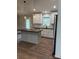 Bright kitchen featuring white cabinets, stainless steel appliances, a center island and modern lighting at 8222 Madison Ln, Hickory, NC 28602