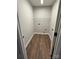 A laundry room space with dark wood flooring and washer hookups at 8222 Madison Ln, Hickory, NC 28602