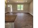 Bright, open living area featuring wood-look floors, a large window, and a front door that lets in natural light at 8222 Madison Ln, Hickory, NC 28602