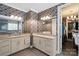Stylish bathroom with double vanity, granite countertops, decorative wallpaper, and ample storage at 8514 Ellington Park Dr, Charlotte, NC 28277