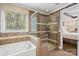 Elegant bathroom with a soaking tub, glass shower, and stylish tile work at 8514 Ellington Park Dr, Charlotte, NC 28277