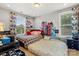 Bright bedroom featuring two beds, playful city decor, and natural light from two windows at 8514 Ellington Park Dr, Charlotte, NC 28277