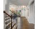Grand foyer with hardwood floors, a chandelier, and elegant staircase with iron railings at 8514 Ellington Park Dr, Charlotte, NC 28277