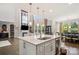 Open kitchen area with a large island, stainless steel appliances, hardwood floors, and a view to the dining area at 8514 Ellington Park Dr, Charlotte, NC 28277