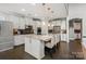 Bright kitchen featuring white cabinetry, stainless steel appliances, large island, and hardwood floors at 8514 Ellington Park Dr, Charlotte, NC 28277
