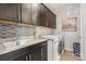 Well-equipped laundry room with modern washer, dryer, granite countertops, and ample cabinet space at 8514 Ellington Park Dr, Charlotte, NC 28277