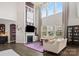 Bright living room with a fireplace, high ceilings, large windows, and hardwood flooring at 8514 Ellington Park Dr, Charlotte, NC 28277