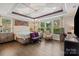 Bright main bedroom with decorative ceiling, large windows, hardwood floors, and ample natural light at 8514 Ellington Park Dr, Charlotte, NC 28277