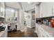 Bright home office space with built-in desk, cabinetry, hardwood floors, and natural light at 8514 Ellington Park Dr, Charlotte, NC 28277