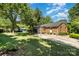 Spacious backyard featuring green lawn, a driveway, and a brick exterior at 8544 Houston Ridge Rd, Charlotte, NC 28277
