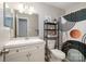 Bathroom with sink and mirror, toilet, and unique shower curtain at 8544 Houston Ridge Rd, Charlotte, NC 28277