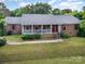 Charming brick home with red shutters and a white porch, nestled on a well-manicured lawn at 8544 Houston Ridge Rd, Charlotte, NC 28277