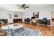 Versatile living room space with hardwood floors, desk, and comfortable seating area at 8544 Houston Ridge Rd, Charlotte, NC 28277