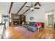 Bright living room featuring a fireplace, wood beam ceiling, hardwood floors, and comfortable seating at 8544 Houston Ridge Rd, Charlotte, NC 28277