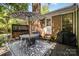 Backyard patio with a lattice fence, gas heater, and outdoor dining set at 8544 Houston Ridge Rd, Charlotte, NC 28277