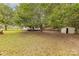 Well-maintained backyard features a storage shed, a mature shade tree, and partial fencing at 10 Bolt Dr, Shelby, NC 28150