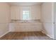 Vintage kitchen featuring white cabinets, a countertop, and a window above the sink at 10 Bolt Dr, Shelby, NC 28150