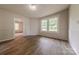 Bright living room with wood-look floors, wainscoting, and an open doorway at 10 Bolt Dr, Shelby, NC 28150